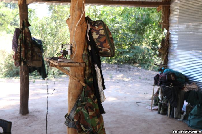 Camouflage uniforms and accessories hang inside the makeshift base camp in Tram Sasar commune of Srey Snam district on Dec. 21, 2017